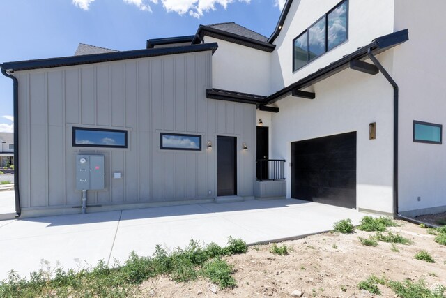 6552 W Timber Ranch Dr, Herriman, UT 84096 - view of front facade featuring board and batten siding, driveway, and stucco siding