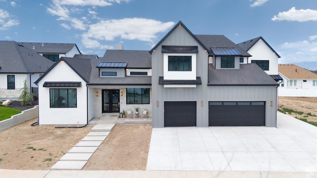 6552 W Timber Ranch Dr, Herriman, UT 84096 - modern farmhouse style home with an attached garage, concrete driveway, a standing seam roof, a shingled roof, and metal roof