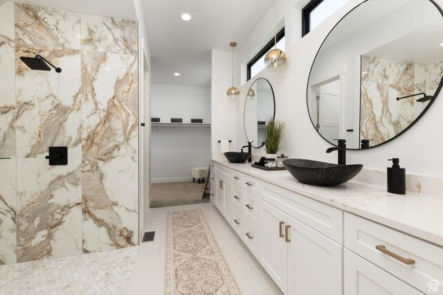6552 W Timber Ranch Dr, Herriman, UT 84096 - full bathroom featuring double vanity, a marble finish shower, recessed lighting, and a walk in closet