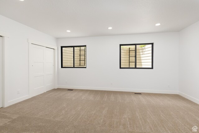 6552 W Timber Ranch Dr, Herriman, UT 84096 - unfurnished bedroom with light carpet, baseboards, multiple windows, and recessed lighting