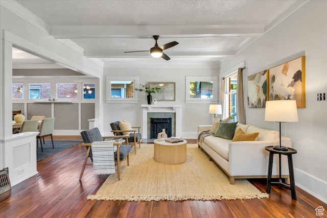 457 S Douglas St E, Salt Lake City, UT 84102 - living area with beamed ceiling, wood-type flooring, baseboards, a fireplace with flush hearth, and a ceiling fan