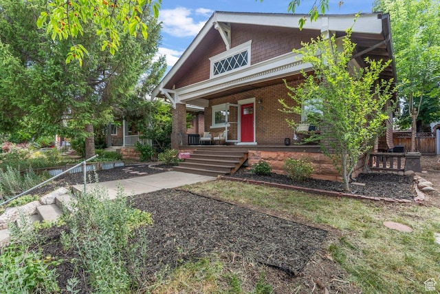 457 S Douglas St E, Salt Lake City, UT 84102 - view of front of house featuring a porch and brick siding