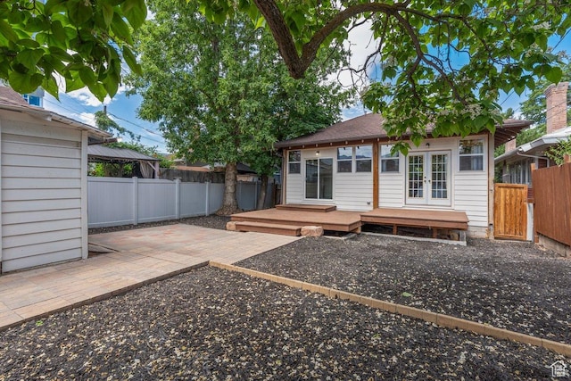 457 S Douglas St E, Salt Lake City, UT 84102 - rear view of house featuring french doors, a fenced backyard, a wooden deck, and a patio