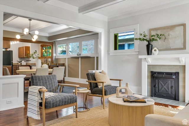 457 S Douglas St E, Salt Lake City, UT 84102 - living area featuring a tile fireplace, beam ceiling, light wood-style floors, and a chandelier