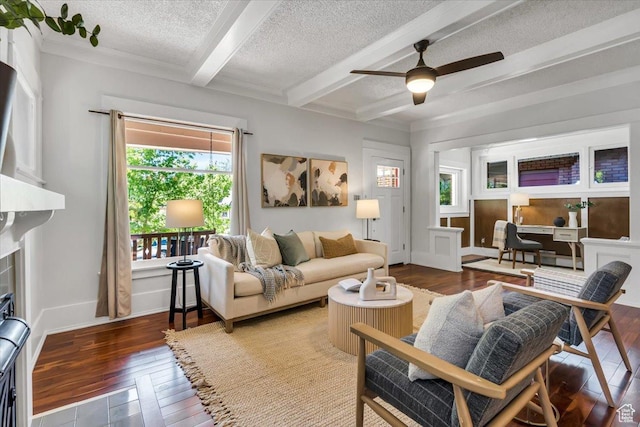 457 S Douglas St E, Salt Lake City, UT 84102 - living area featuring hardwood / wood-style flooring, beamed ceiling, a textured ceiling, a ceiling fan, and a fireplace