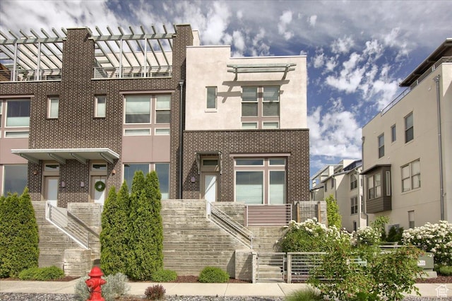 4508 W Kestrel Ridge Rd, South Jordan, UT 84009 - view of front of property with stairway, brick siding, and stucco siding