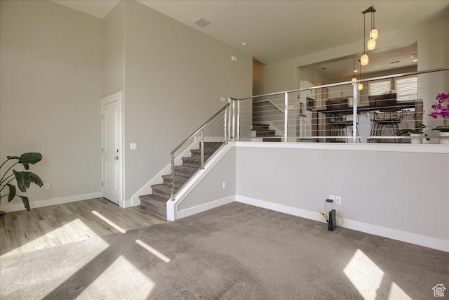 4508 W Kestrel Ridge Rd, South Jordan, UT 84009 - unfurnished living room with stairs, carpet, baseboards, and wood finished floors