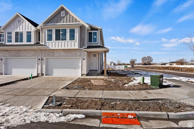 1687 W 2770 S Unit 204, Syracuse, UT 84075 - multi unit property with board and batten siding, brick siding, concrete driveway, and an attached garage