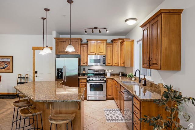 5519 Lillehammer Ln Unit 1307, Park City, UT 84098 - kitchen with stainless steel appliances, a sink, light tile patterned floors, and brown cabinetry