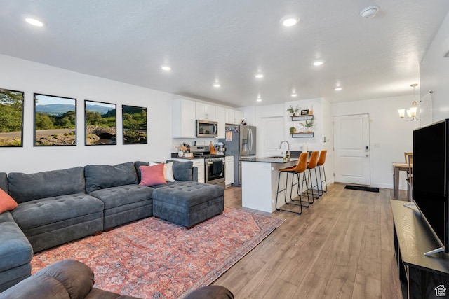 41 N Voyager Ln, Saratoga Springs, UT 84045 - living area featuring light wood-style floors, recessed lighting, and a chandelier