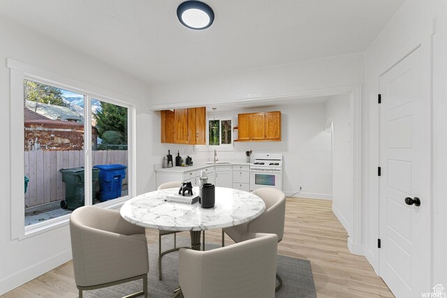 1167 29th St, Ogden, UT 84403 - dining space with baseboards and light wood-style floors