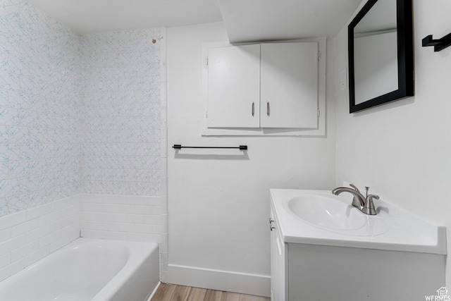 1167 29th St, Ogden, UT 84403 - bathroom with vanity, wood finished floors, baseboards, and washtub / shower combination