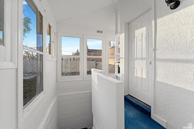 1167 29th St, Ogden, UT 84403 - unfurnished sunroom with plenty of natural light, a textured wall, and vaulted ceiling