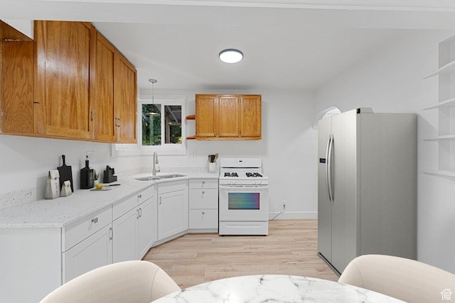 1167 29th St, Ogden, UT 84403 - kitchen featuring white gas range oven, a sink, refrigerator with ice dispenser, open shelves, and light wood-style flooring