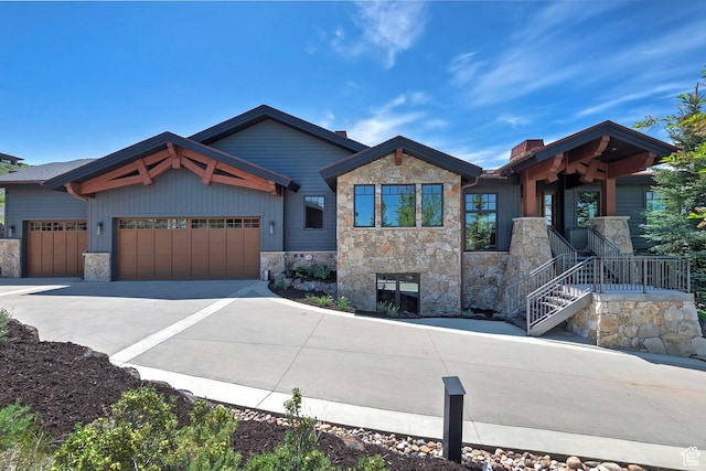 3428 Westview Trl, Park City, UT 84098 - view of front facade with stone siding, a garage, concrete driveway, and a chimney