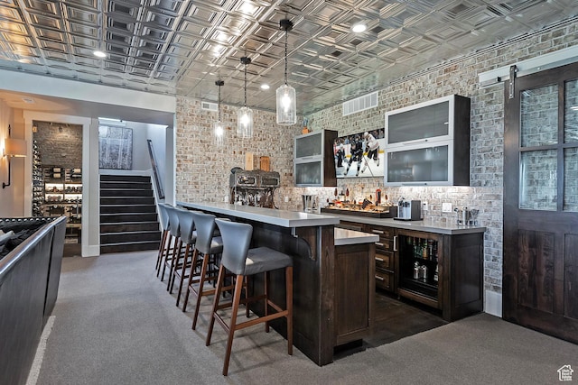3428 Westview Trl, Park City, UT 84098 - indoor wet bar with an ornate ceiling, stairs, hanging light fixtures, brick wall, and dark colored carpet