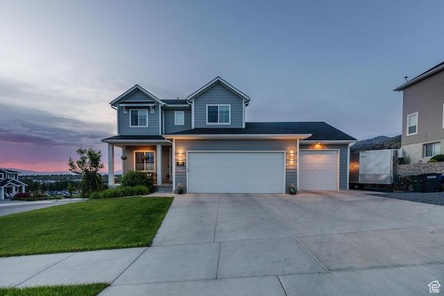 611 E 400 N, Providence, UT 84332 - view of front of home with concrete driveway, a front yard, and a garage