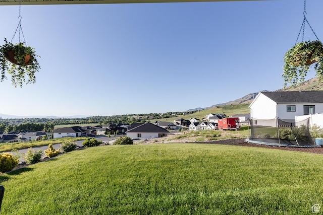 611 E 400 N, Providence, UT 84332 - view of green lawn featuring a residential view, a mountain view, and a trampoline
