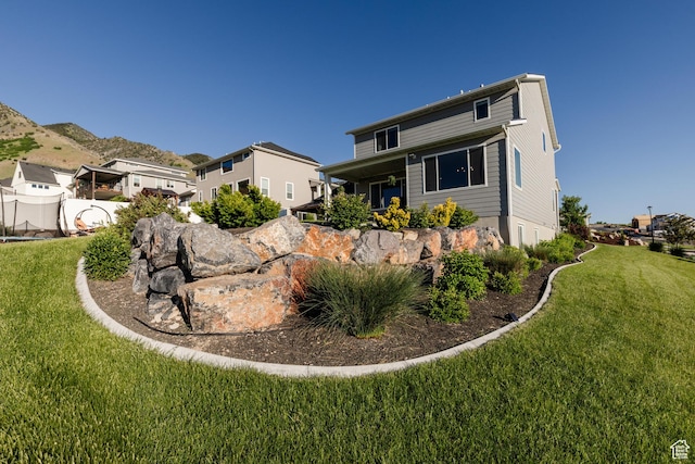 611 E 400 N, Providence, UT 84332 - view of front of property featuring a front lawn and a mountain view
