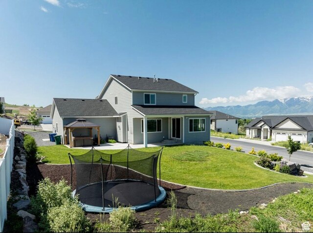 611 E 400 N, Providence, UT 84332 - rear view of house featuring a trampoline, a gazebo, and a mountain view