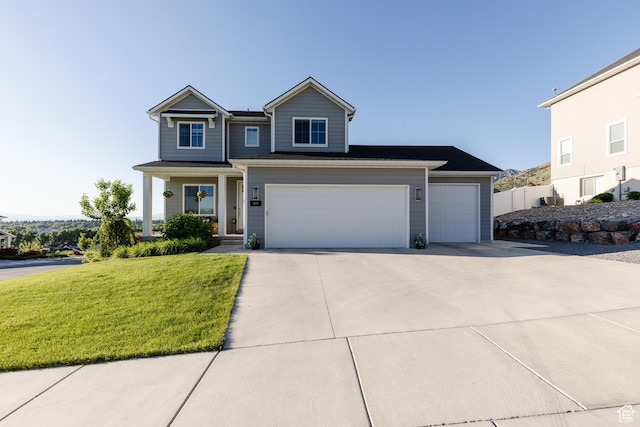 611 E 400 N, Providence, UT 84332 - view of front of house with concrete driveway, a front lawn, and an attached garage