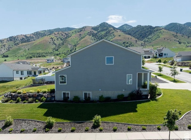 611 E 400 N, Providence, UT 84332 - view of home's exterior featuring a mountain view, a lawn, and a residential view
