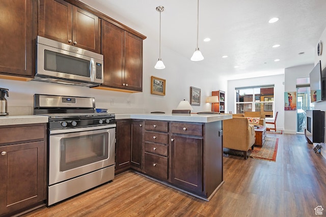 1370 Center Dr Unit 17, Kimball Junction, UT 84098 - kitchen featuring appliances with stainless steel finishes, wood finished floors, a peninsula, light countertops, and recessed lighting