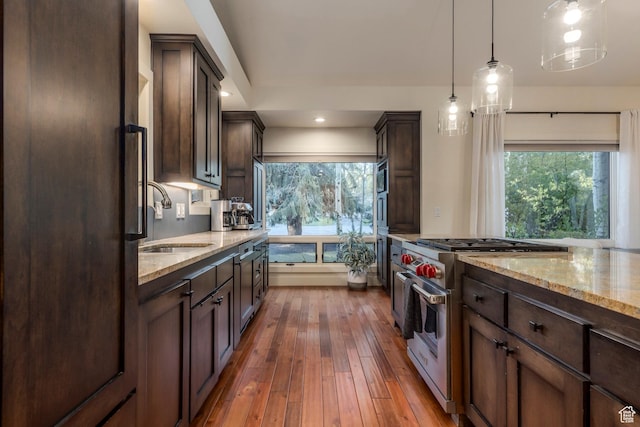 2126 Twilight Ct, Park City, UT 84060 - kitchen with appliances with stainless steel finishes, a sink, dark brown cabinetry, light stone countertops, and recessed lighting