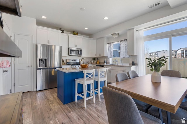 723 E 380 S, American Fork, UT 84003 - kitchen with appliances with stainless steel finishes, healthy amount of natural light, a center island, white cabinets, and recessed lighting