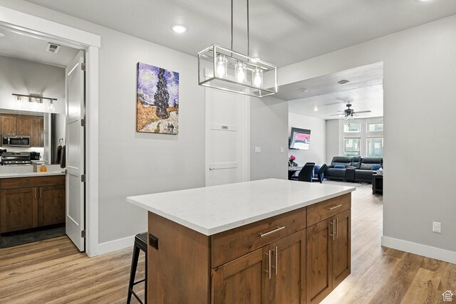 899 S Lincoln Ave Unit 3, Cedar City, UT 84720 - kitchen featuring stainless steel microwave, light wood finished floors, baseboards, and recessed lighting