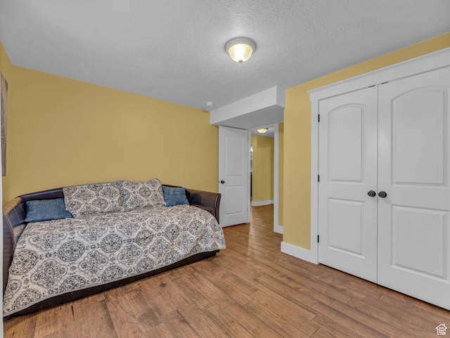 1872 N 1850 E, North Logan, UT 84341 - bedroom featuring wood finished floors, a closet, a textured ceiling, and baseboards