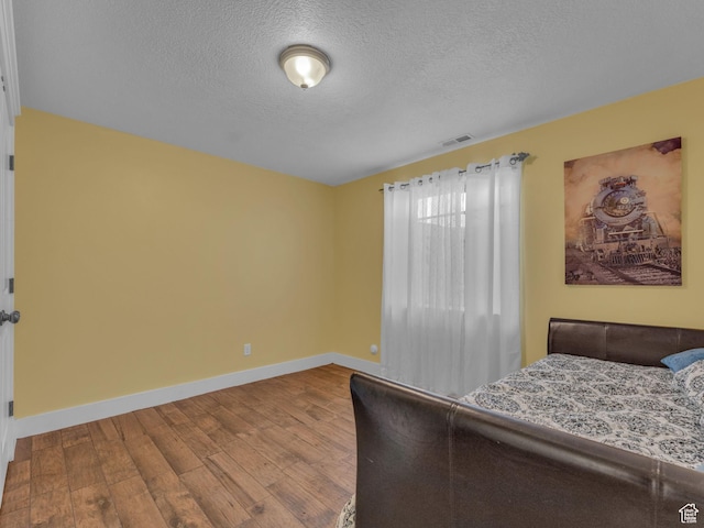 1872 N 1850 E, North Logan, UT 84341 - bedroom featuring wood finished floors, baseboards, and a textured ceiling