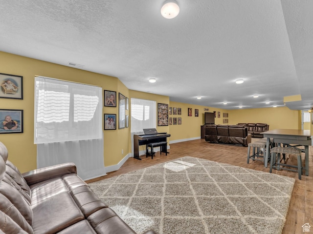 1872 N 1850 E, North Logan, UT 84341 - living room featuring a textured ceiling, wood finished floors, and baseboards
