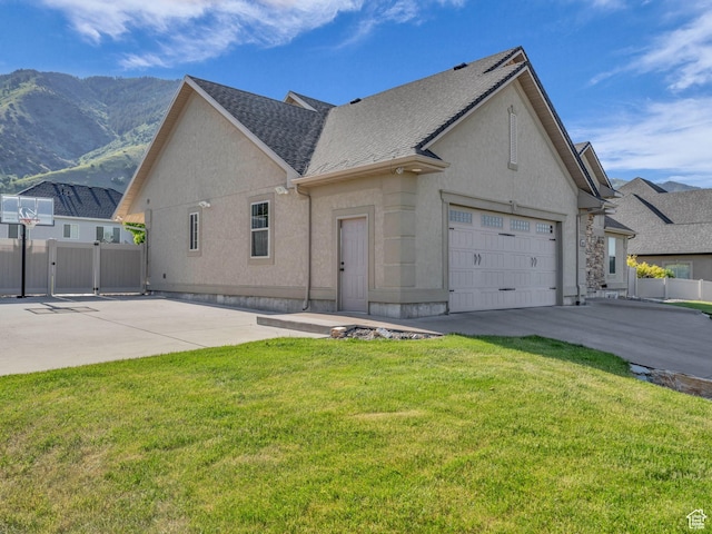 1872 N 1850 E, North Logan, UT 84341 - view of front facade with driveway, stucco siding, a mountain view, an attached garage, and a gate