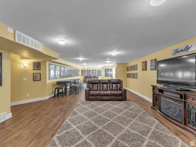 1872 N 1850 E, North Logan, UT 84341 - living area with a textured ceiling, baseboards, and wood finished floors