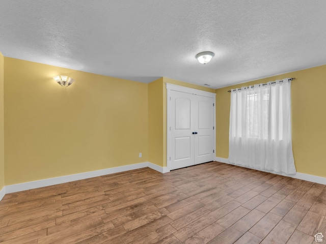 1872 N 1850 E, North Logan, UT 84341 - empty room with a textured ceiling, baseboards, and wood finished floors