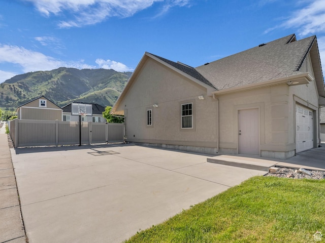 1872 N 1850 E, North Logan, UT 84341 - view of property exterior with a mountain view, a shingled roof, and stucco siding