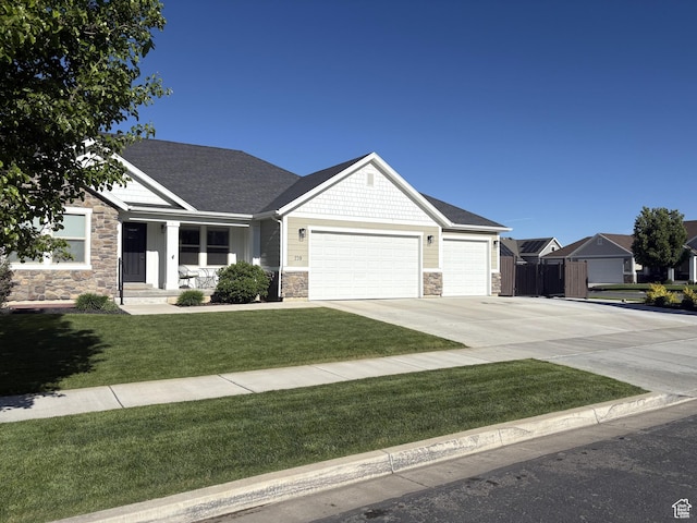 239 N 2400 E, Spanish Fork, UT 84660 - craftsman house featuring stone siding, a garage, concrete driveway, and a shingled roof