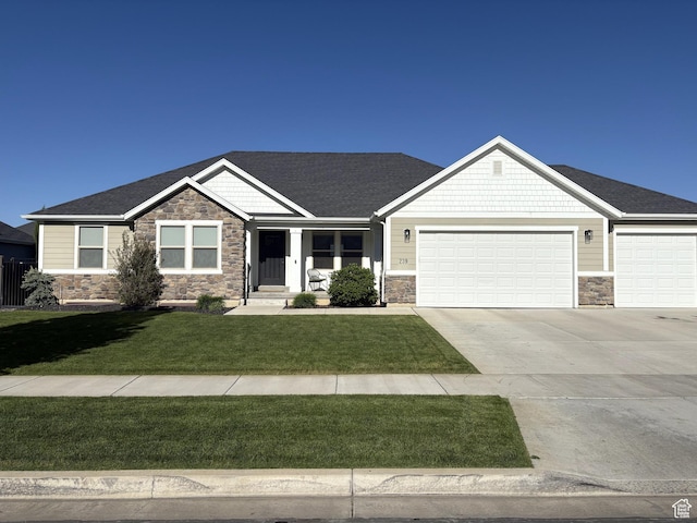 239 N 2400 E, Spanish Fork, UT 84660 - craftsman-style home featuring stone siding, a garage, and concrete driveway