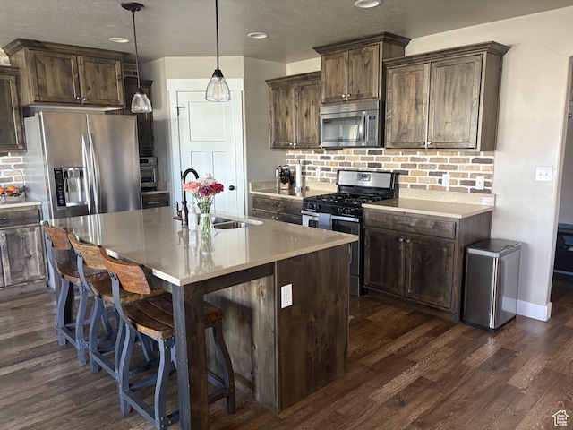 239 N 2400 E, Spanish Fork, UT 84660 - kitchen with appliances with stainless steel finishes, a sink, tasteful backsplash, dark wood finished floors, and recessed lighting