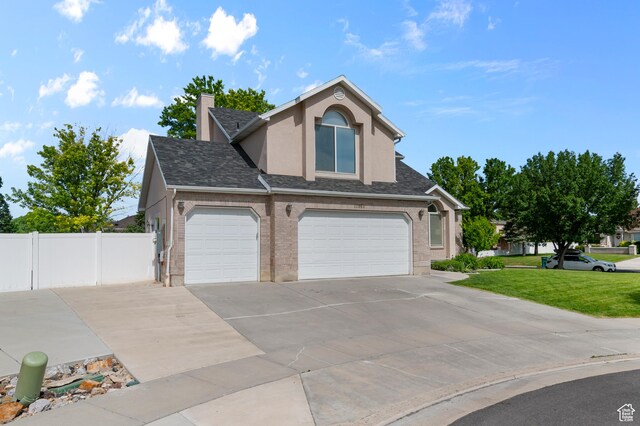12064 S Fastback Cir, Riverton, UT 84065 - traditional-style house with driveway, stucco siding, a garage, a shingled roof, and a chimney