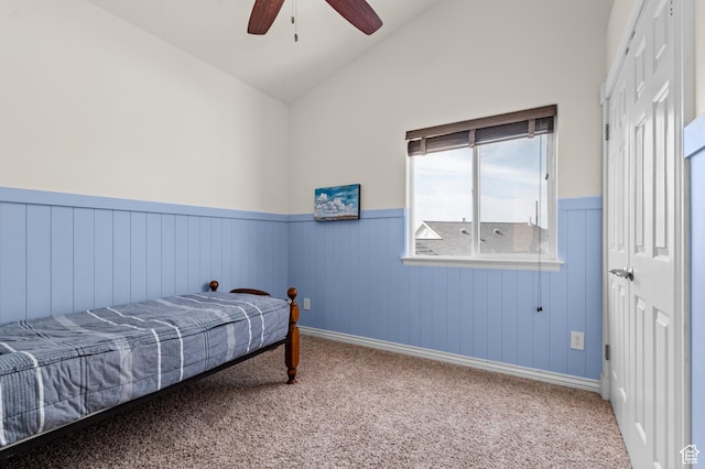 12064 S Fastback Cir, Riverton, UT 84065 - bedroom featuring a wainscoted wall, vaulted ceiling, carpet flooring, a ceiling fan, and a closet