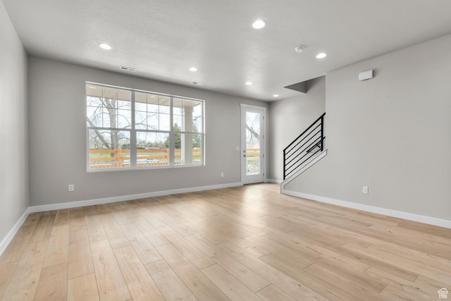 746 W Signal Dr, Salt Lake City, UT 84123 - unfurnished living room featuring stairway, recessed lighting, baseboards, and light wood-style flooring