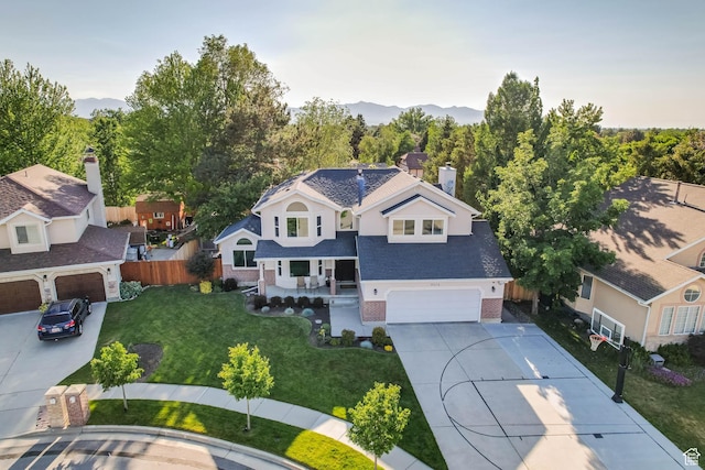9574 S Equestrian Park Cir, Sandy, UT 84092 - view of front of property featuring driveway, a porch, a mountain view, and an attached garage