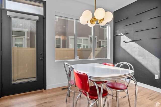 15223 S Wild Horse Way, Bluffdale, UT 84065 - dining room with a chandelier, wood finished floors, and baseboards