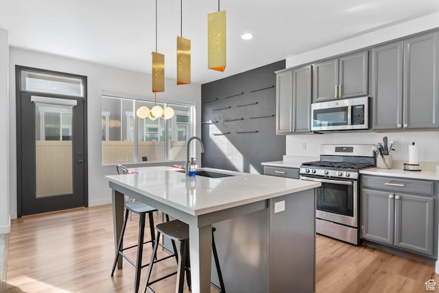 15223 S Wild Horse Way, Bluffdale, UT 84065 - kitchen with appliances with stainless steel finishes, gray cabinets, an island with sink, and recessed lighting