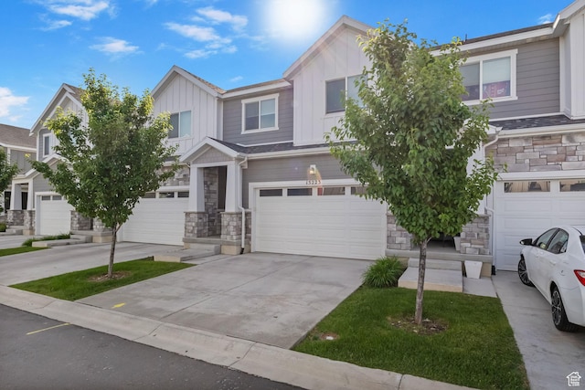 15223 S Wild Horse Way, Bluffdale, UT 84065 - view of front facade with stone siding, an attached garage, board and batten siding, and concrete driveway