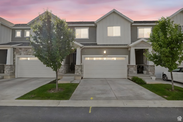 15223 S Wild Horse Way, Bluffdale, UT 84065 - view of front of house with stone siding, an attached garage, board and batten siding, and concrete driveway