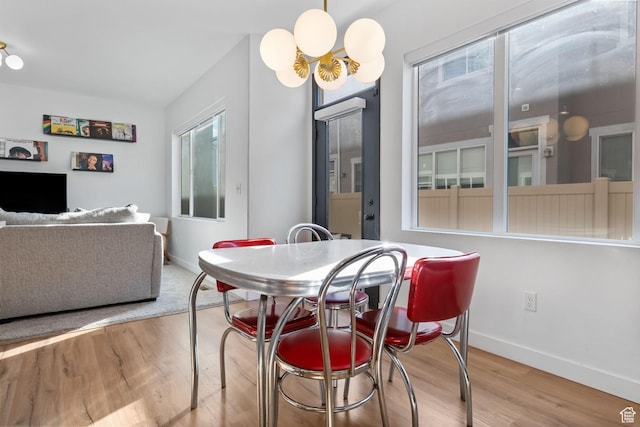 15223 S Wild Horse Way, Bluffdale, UT 84065 - dining space featuring baseboards, wood finished floors, and a chandelier