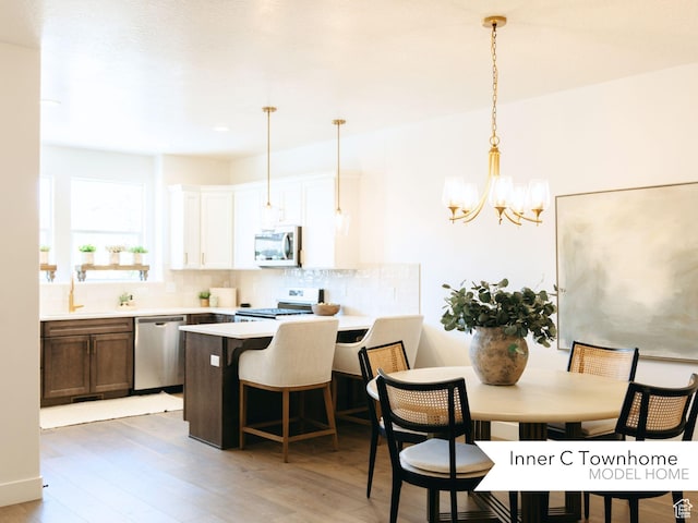 1077 N Canvasback Dr Unit 410, Lehi, UT 84043 - dining space with light wood-style flooring and a chandelier